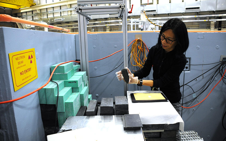 Heather Chen-Mayer loading a jade artifact into a neutron detector