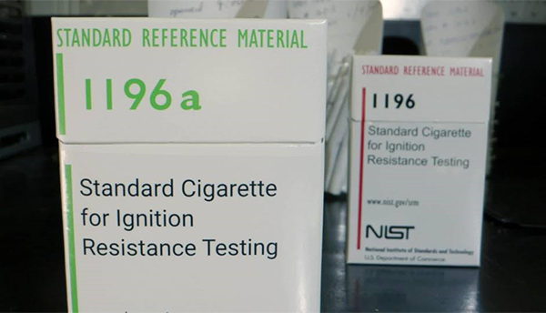 A box of cigarettes is labeled: Standard Cigarette for Ignition Resistance Testing.