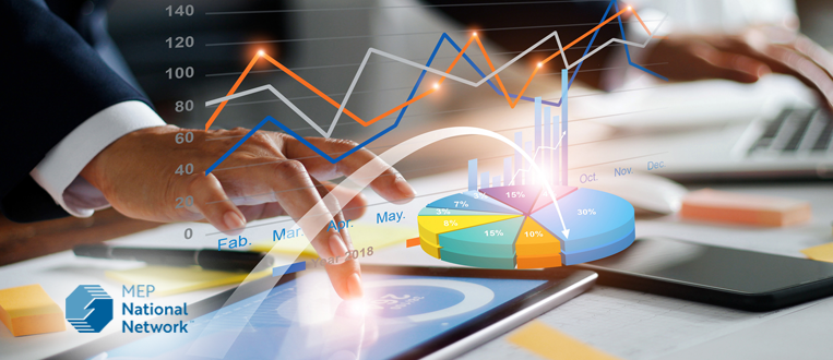 Businessman using tablet and laptop analyzing sales data and economic growth graph chart.