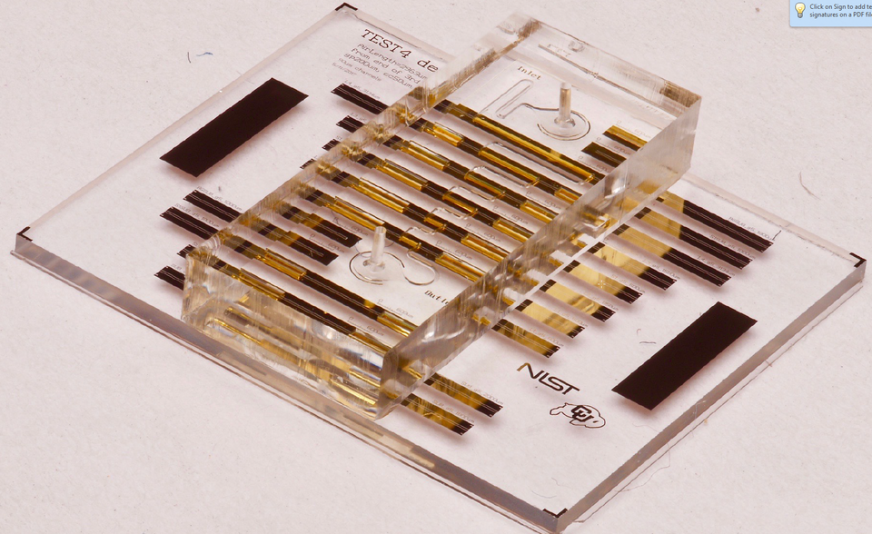 A transparent chip has metallic bars crossing it. 