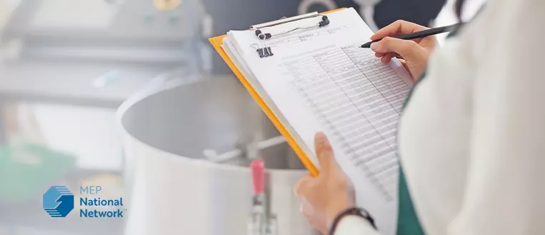 Woman checking quality of food in a manufacturing facility