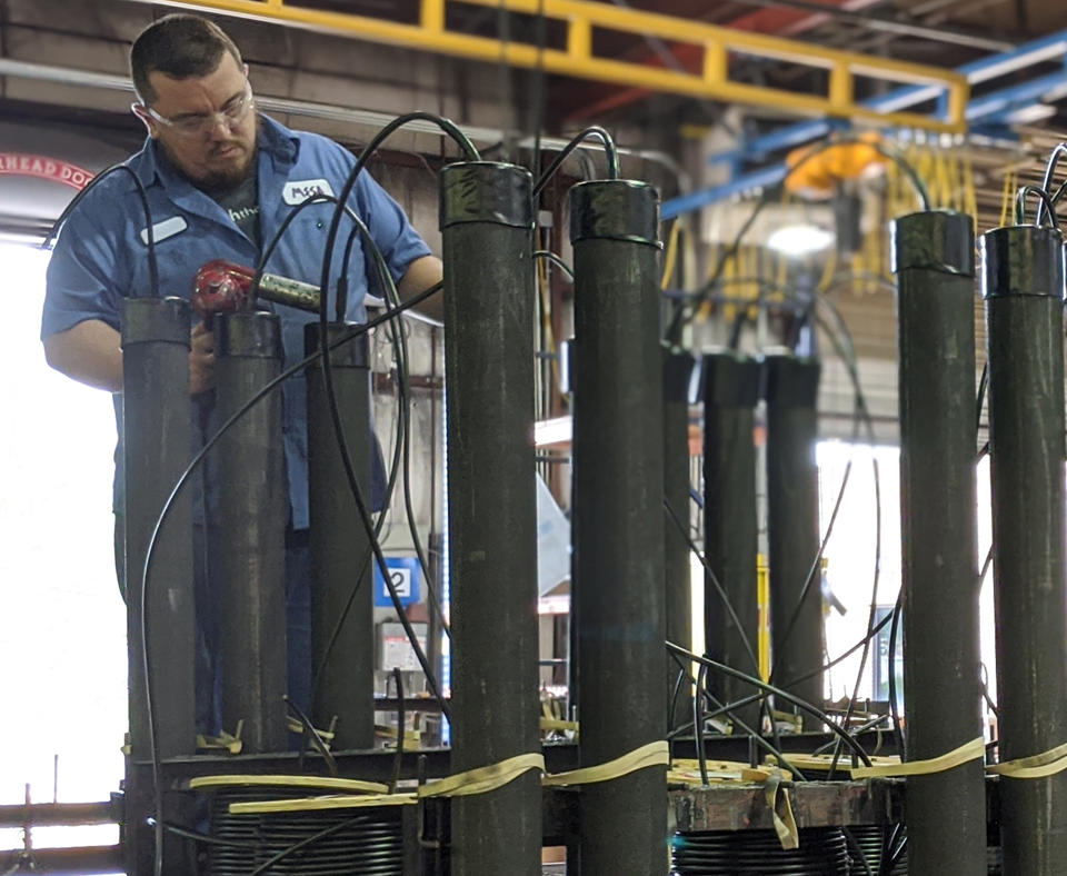 MESA 2020 Baldrige Award Recipient in Small Business employee working steel pipelines to prevent corrosion.