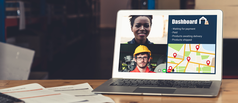 Warehouse staff talking on video call at computer screen in storage warehouse