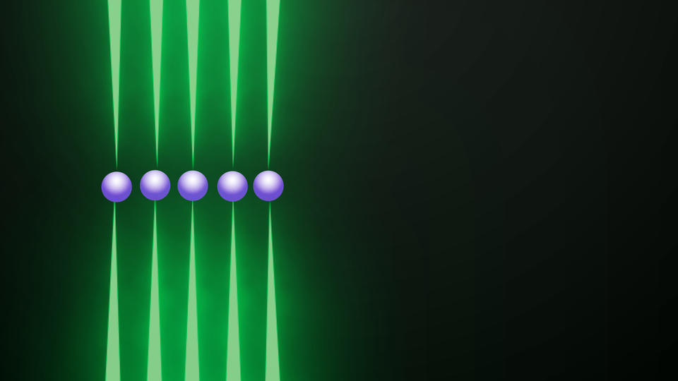 Row of five purple spheres, each held top and bottom by tips of long green probes, on black background.