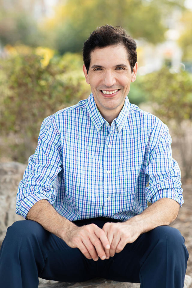 Photograph of Ben P. Stein wearing  blue and green plaid shirt outdoors