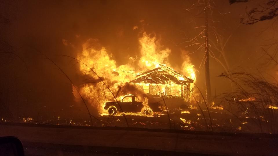 A house, truck and trees burn.