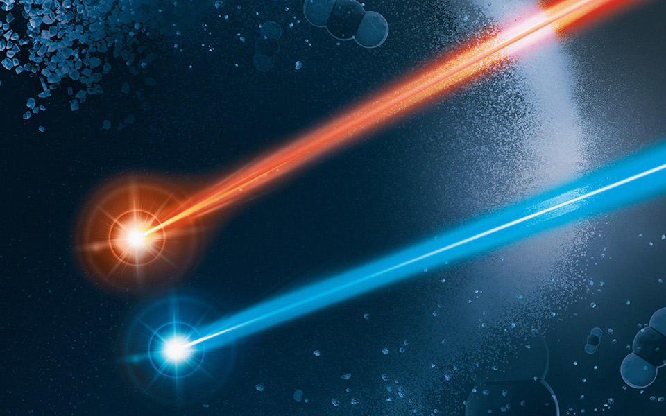 small grains of a reference material disappearing or floating away. two lasers, red and blue, which represent the two different colored lasers used by the instrument. Also visible are linear molecules of carbon dioxide (collections of three balls), CO2.