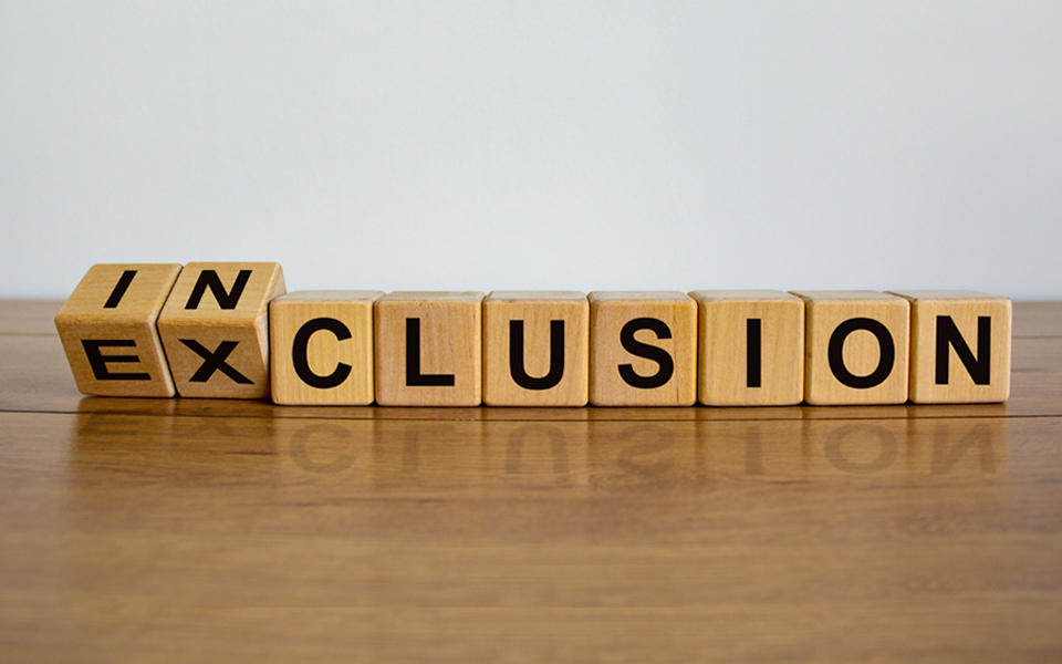 Blocks on a table spelling Inclusion.