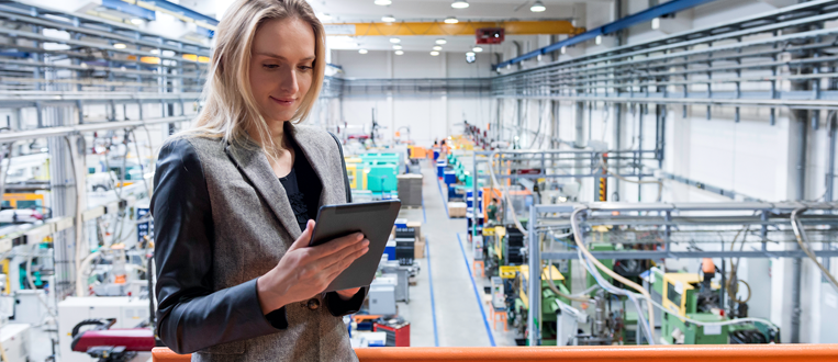 female manufacturing worker on a tablet with advanced manufacturing technologies