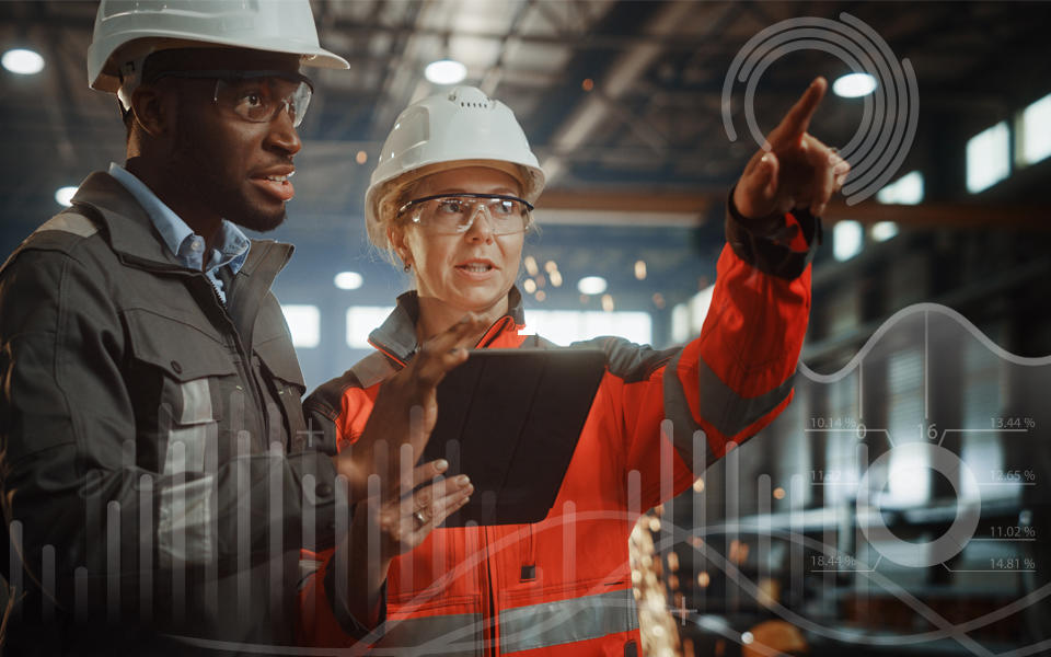 A woman and a man heavy industry engineers stand in steel metal manufacturing factory, use digital tablet and having a discussion.