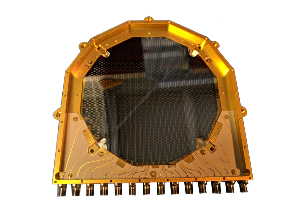 Gold-colored device has circular opening and attachments on one side.