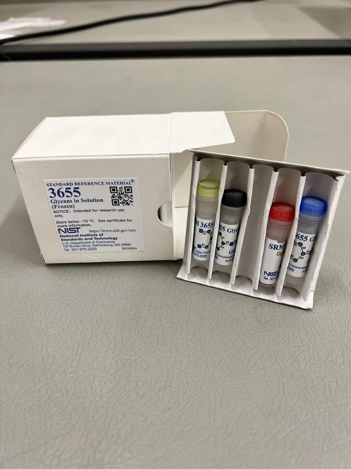 A white box is open with a special tray holding vials with different-colored caps.