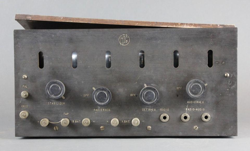 Rectangular instrument panel for historical radio device has dials and other controls.