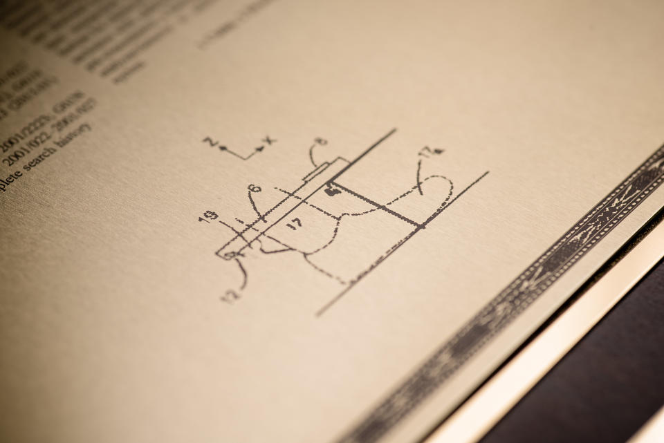 Diagram from patent, shown in diagonal photo, shows shoe labeled lines around it.