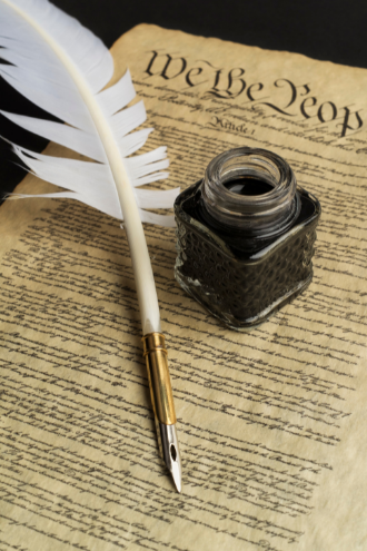 Photo of U.S. Constitution with quill pen and ink jar