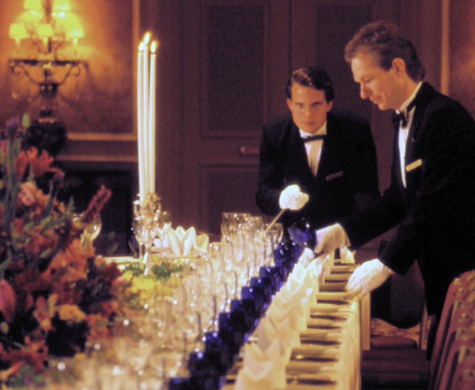Two "Gentlemen of The Ritz-Carlton"—are front-line workers in hotels preparing for an event.