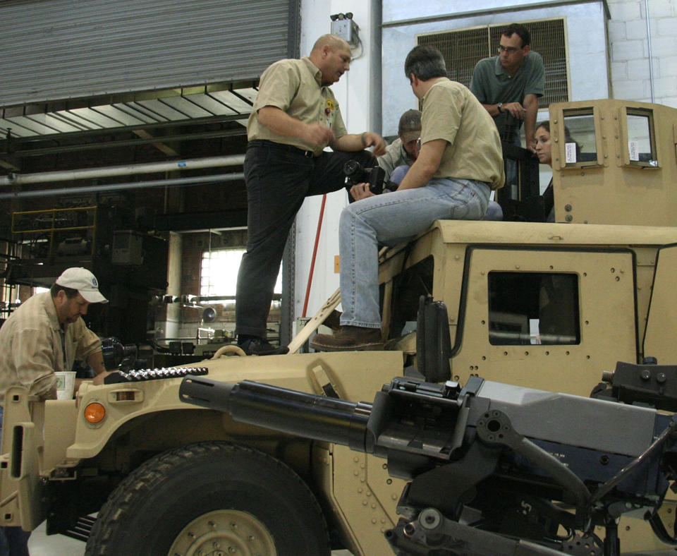U.S. Army Armament Research, Development and Engineering Center (ARDEC) military working on an Army tank.