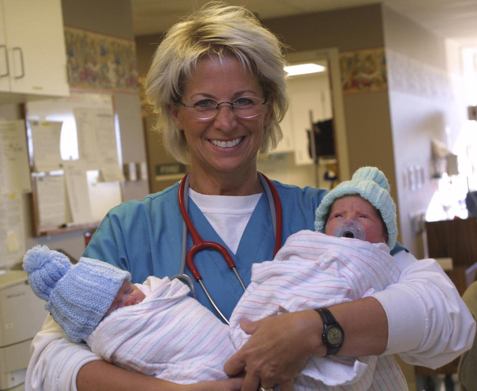 2008 Baldrige Award Recipient Poudre Valley Health System showing a nurse holding two newborn babies.