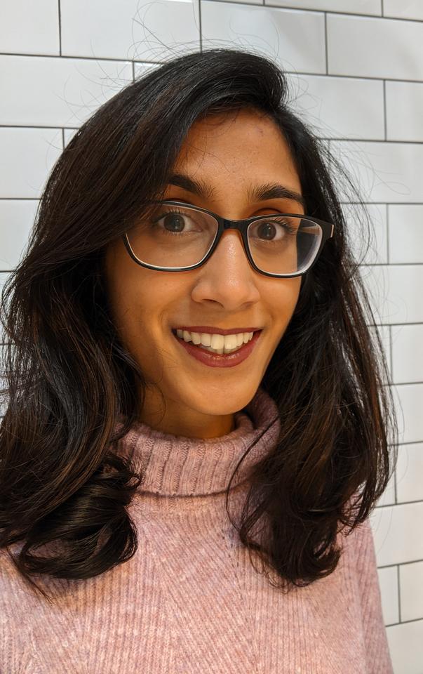 Headshot of Ramya Gurunathan. Glasses, sweater