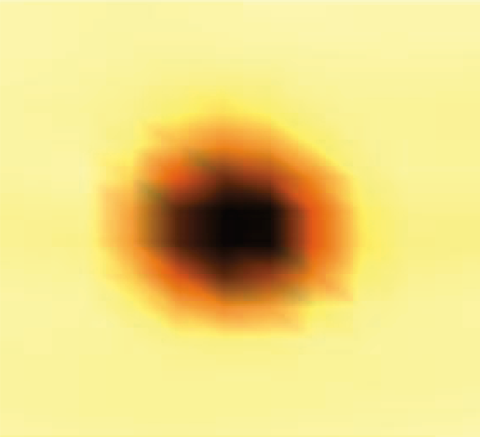 A blurry dark circle lightens at the edges on a yellow background.