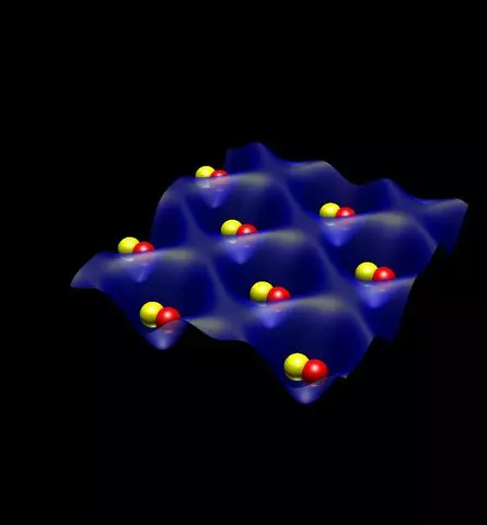 Black background. Blue structure that looks like an egg carton with red and yellow globes in each pocket 
