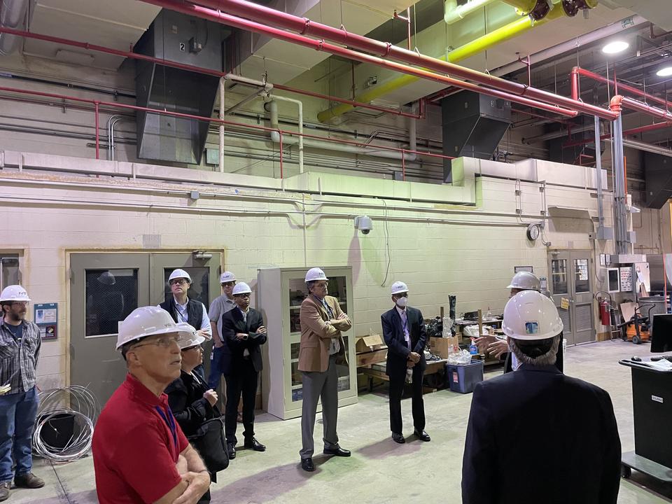 Individuals in hard hats in a lab