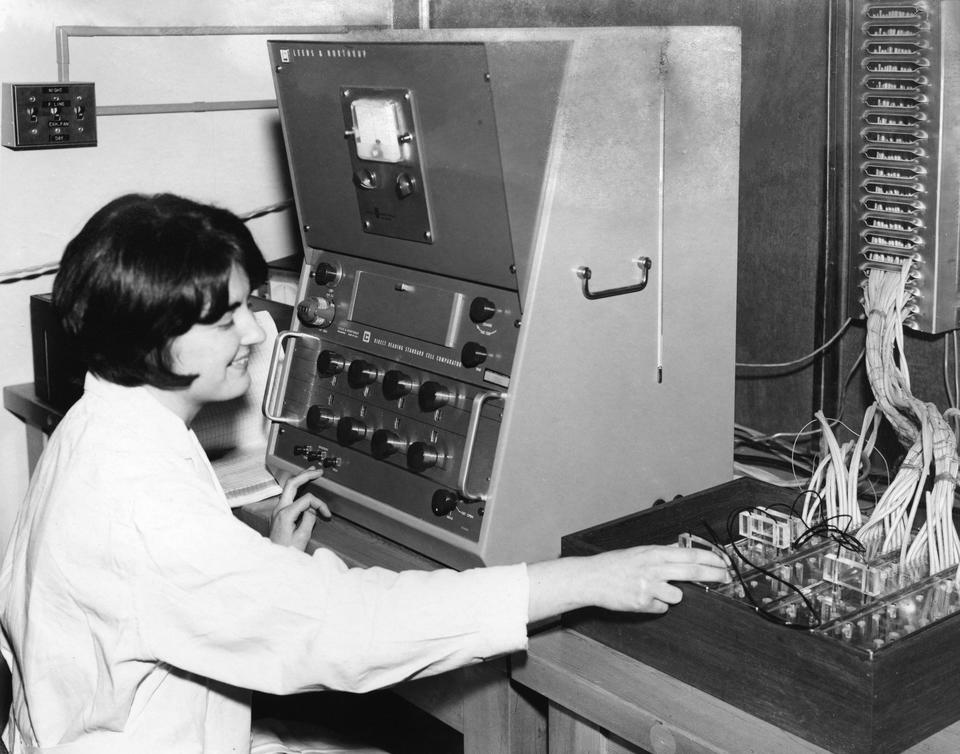 A woman in a lab coat working with electricity cells