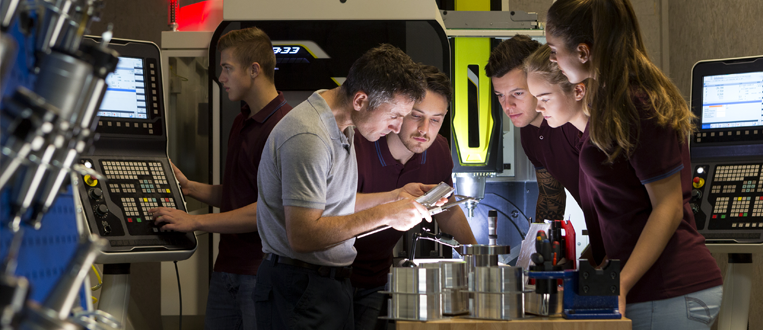 Group of student apprentices in a manufacturing facility