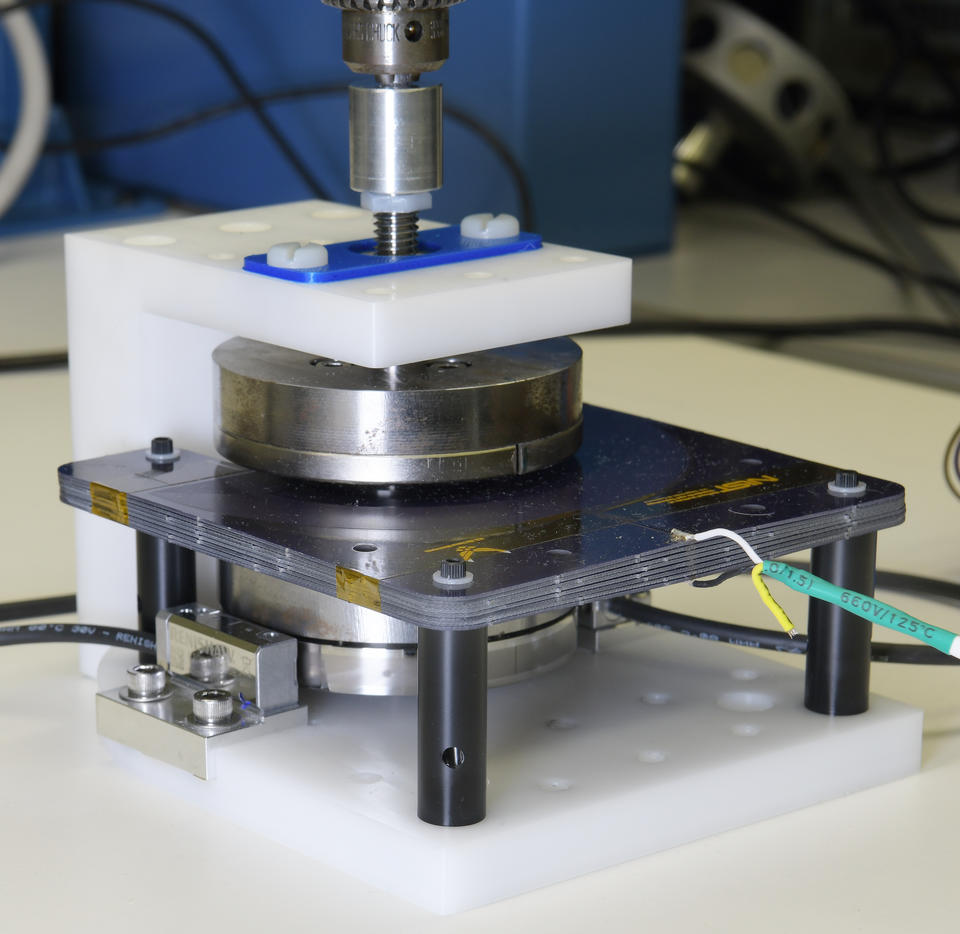 Scientific device includes circular magnets mounted on a black platform wired to other components.