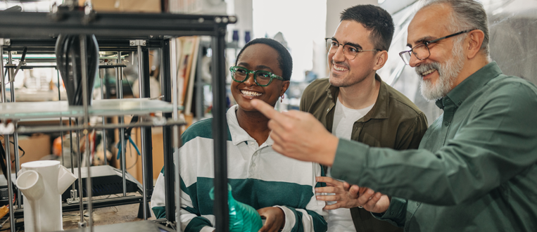 One senior man explaining students 3d printing