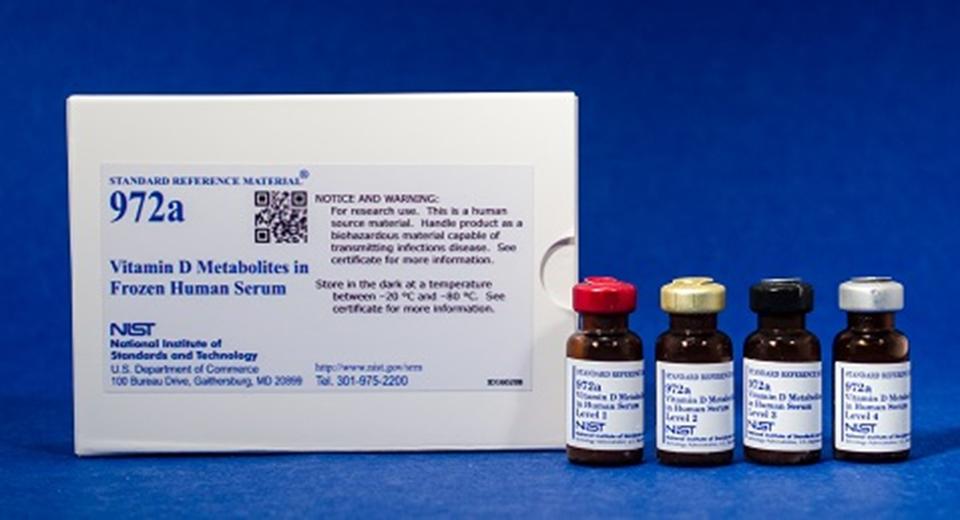 Photograph of SRM 972a Vitamin D metabolites in Frozen Human Serum showing a labeled box and four bottles labeled level 1 to level 4.