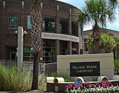 Photograph of the exterior of the Hollings Marine Laboratory (HML), with signs designation the facility. 