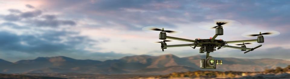 Image of a drone in front of the mountains