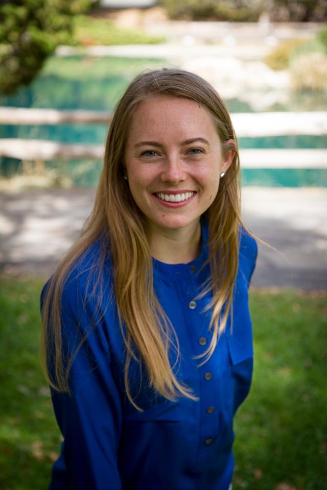 Headshot of a woman in a blue shirt