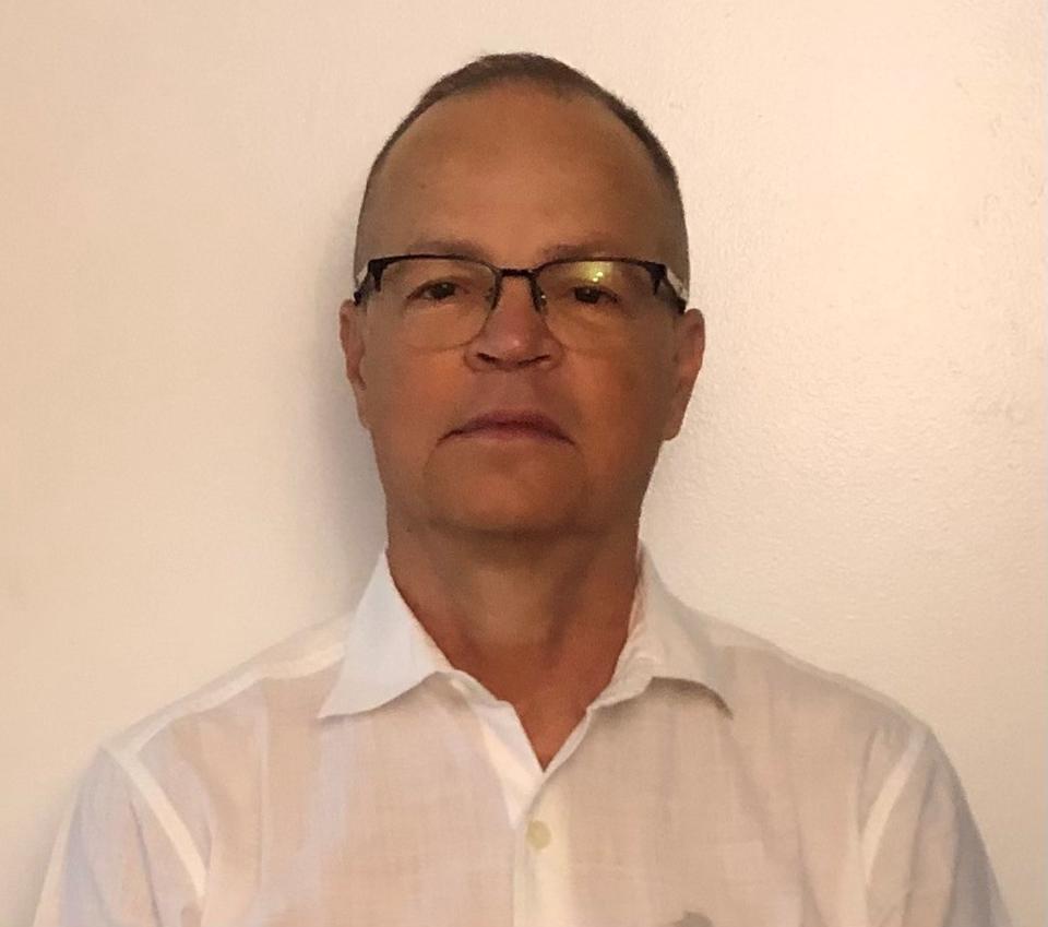 Man in white shirt wearing glasses