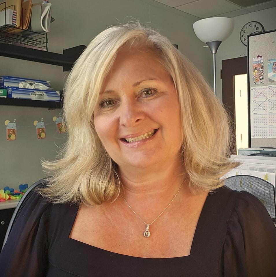 smiling woman in blonde hair in an office setting