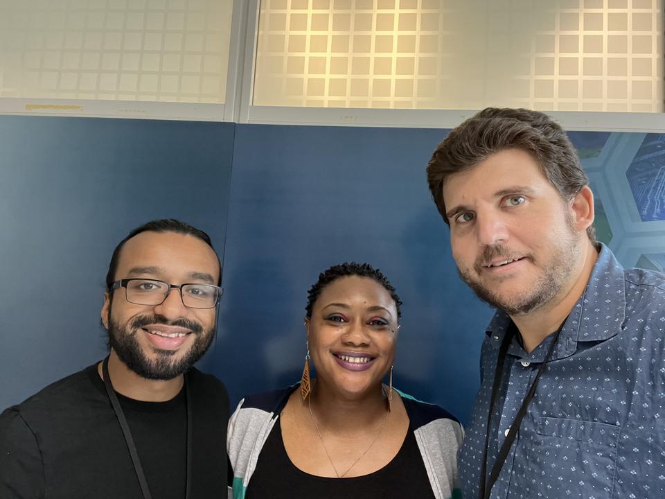 three smiling people