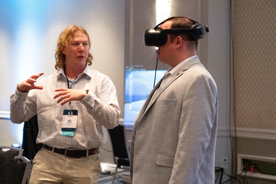 PSCR staff member demoing an AR headset with a 5x5 attendee