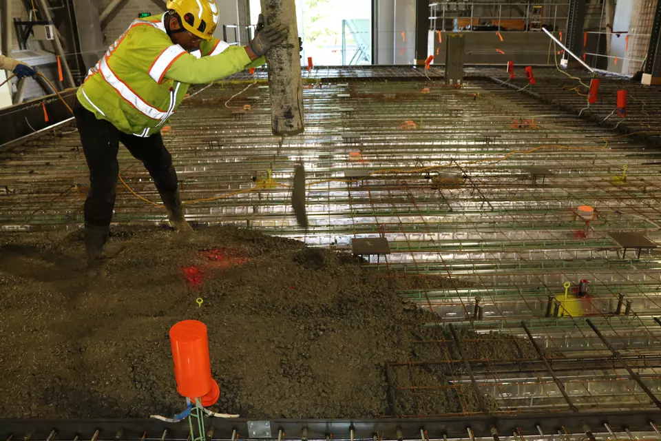 Man in a hardhat installing a floor