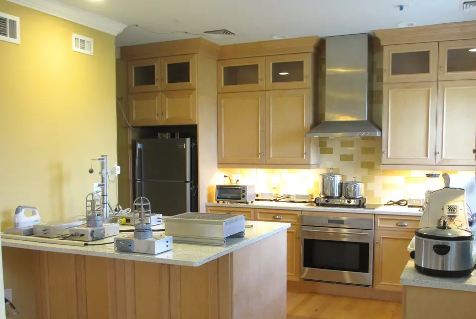 A high-end residential kitchen contains both normal cookware and appliances and scientific equipment. 
