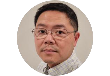 person with short black hair and glasses