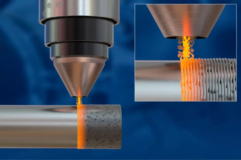 a closeup view of a nozzle spraying/depositing melted material onto a metal surface