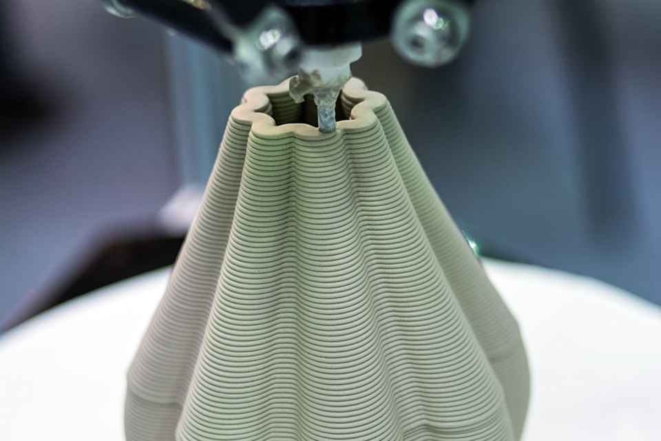a 3D printer prints a ceramic vase