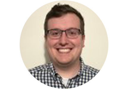NIST's Austin Colon, a person with short brown hair and glasses, smiles for the camera