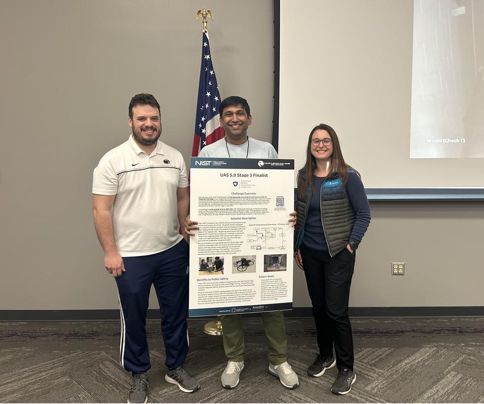 Image of ARCC team members at UAS 5.0 Stage 3 live event; they are holding their Stage 3 solution overview poster.