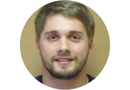 NIST's James Zuback, a person with short light brown hair and a beard, smiles for the camera