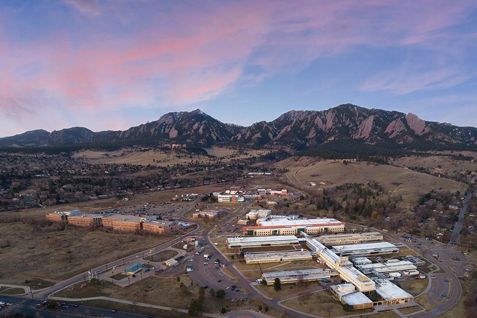 Early morning aerial view of NIST's Boulder, Colorado, campus, the Flatiron Mountains are in the background.