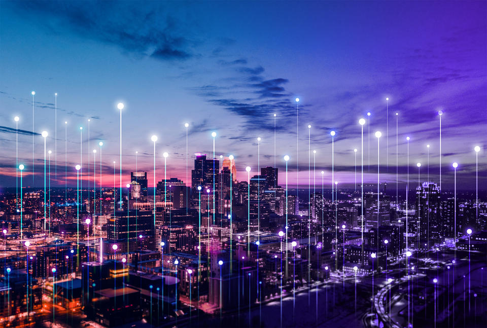 Stylized network connection points rise above a city skyline at sunset.