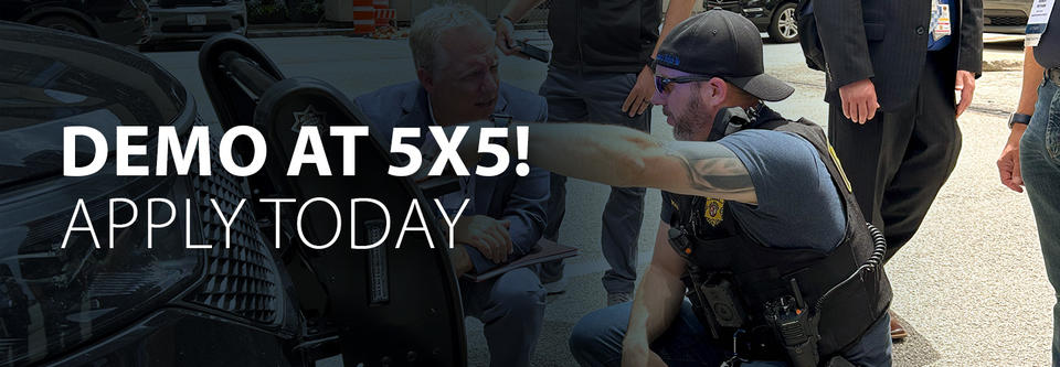 Two men participating in tech demo at 5x5 2024 in Chicago.