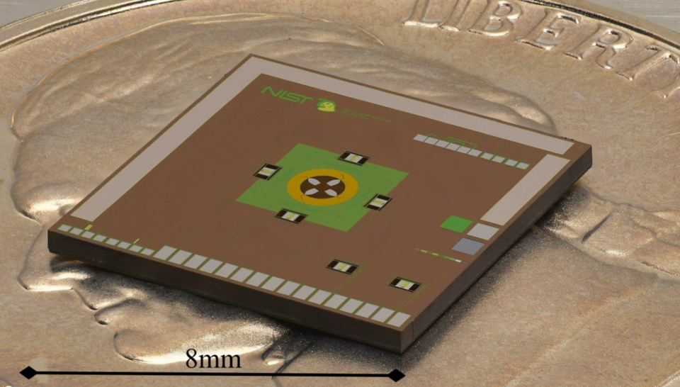 Close-up photo of a square chip with electronics on the surface and a scale line reading: 8mm.